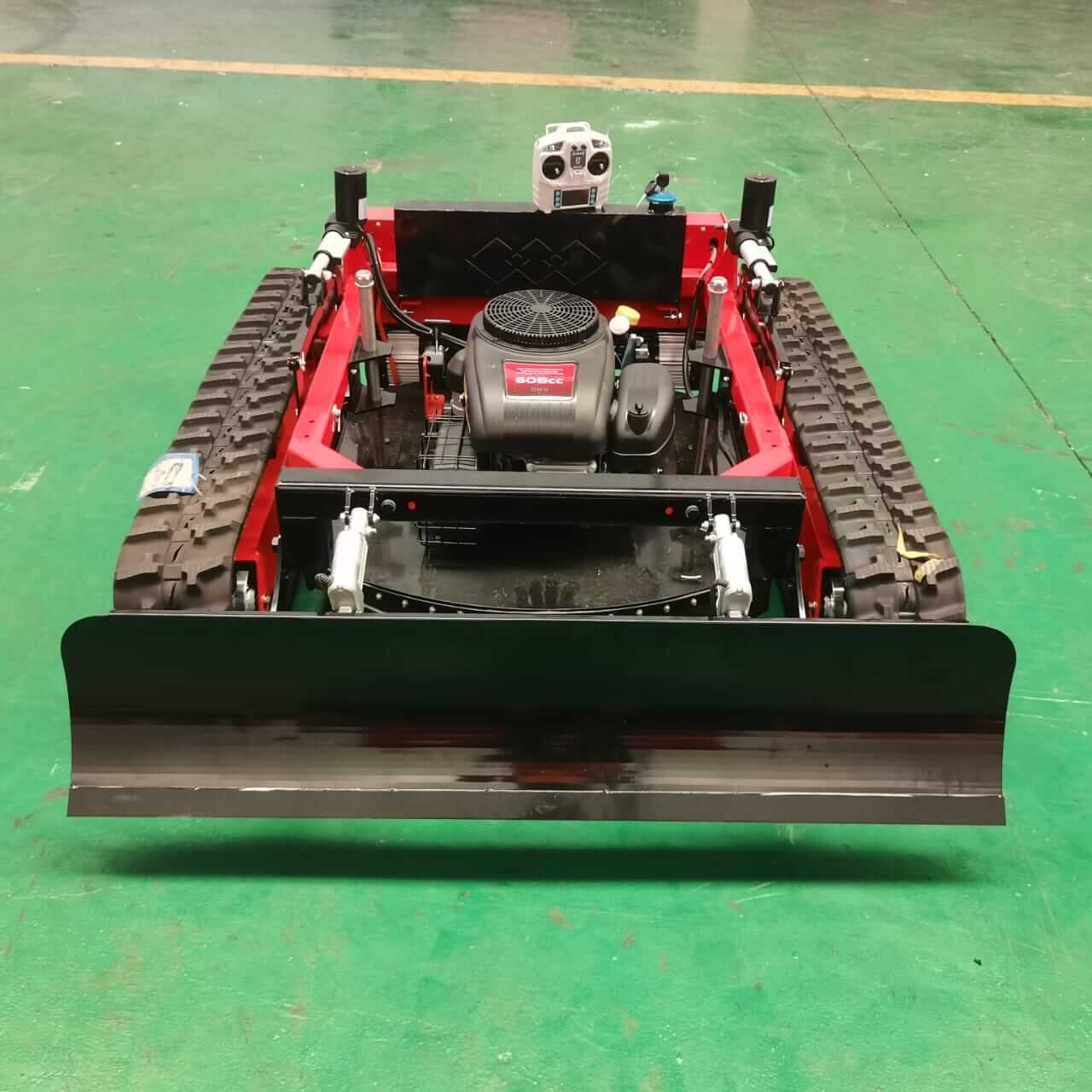 Remote control all-terrain lawn mower with tracks and powerful engine for extreme terrain performance.