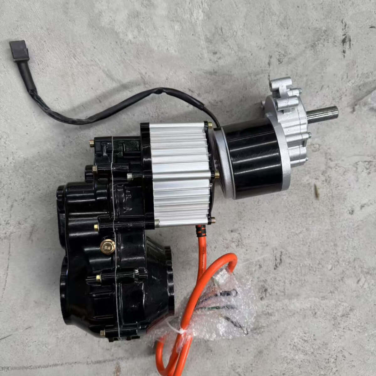 Remote control slope mower price part, featuring motor assembly with wires and connectors on a concrete surface.