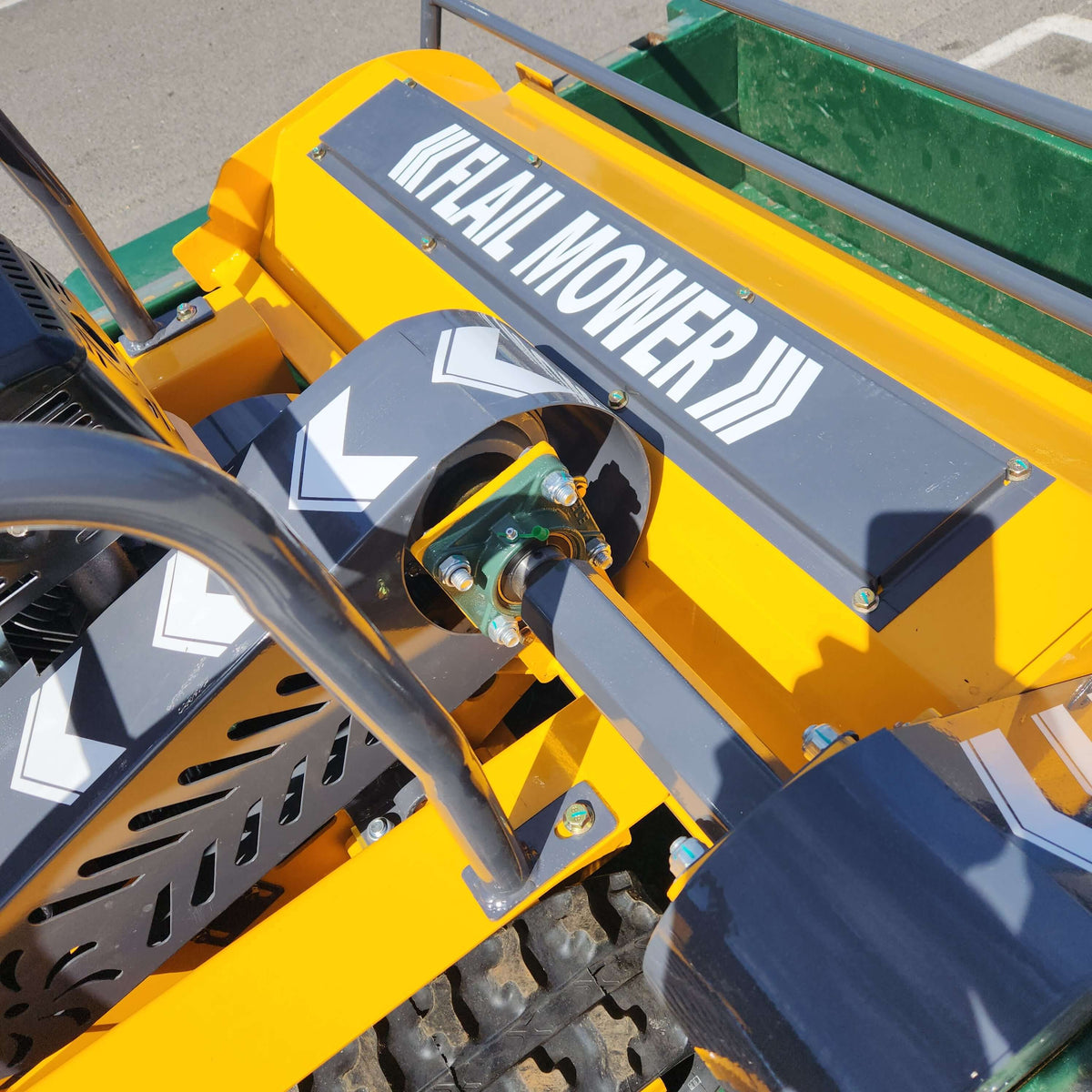 Remote control flail mower close-up showing the cutting mechanism and branding on the machine.