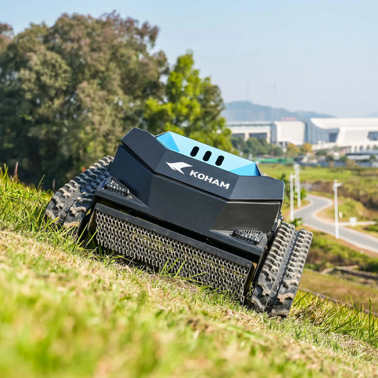 RC lawn mower on grass with trees and buildings in the background