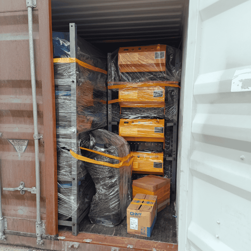 Packed radio controlled lawn mowers and equipment in a shipping container.