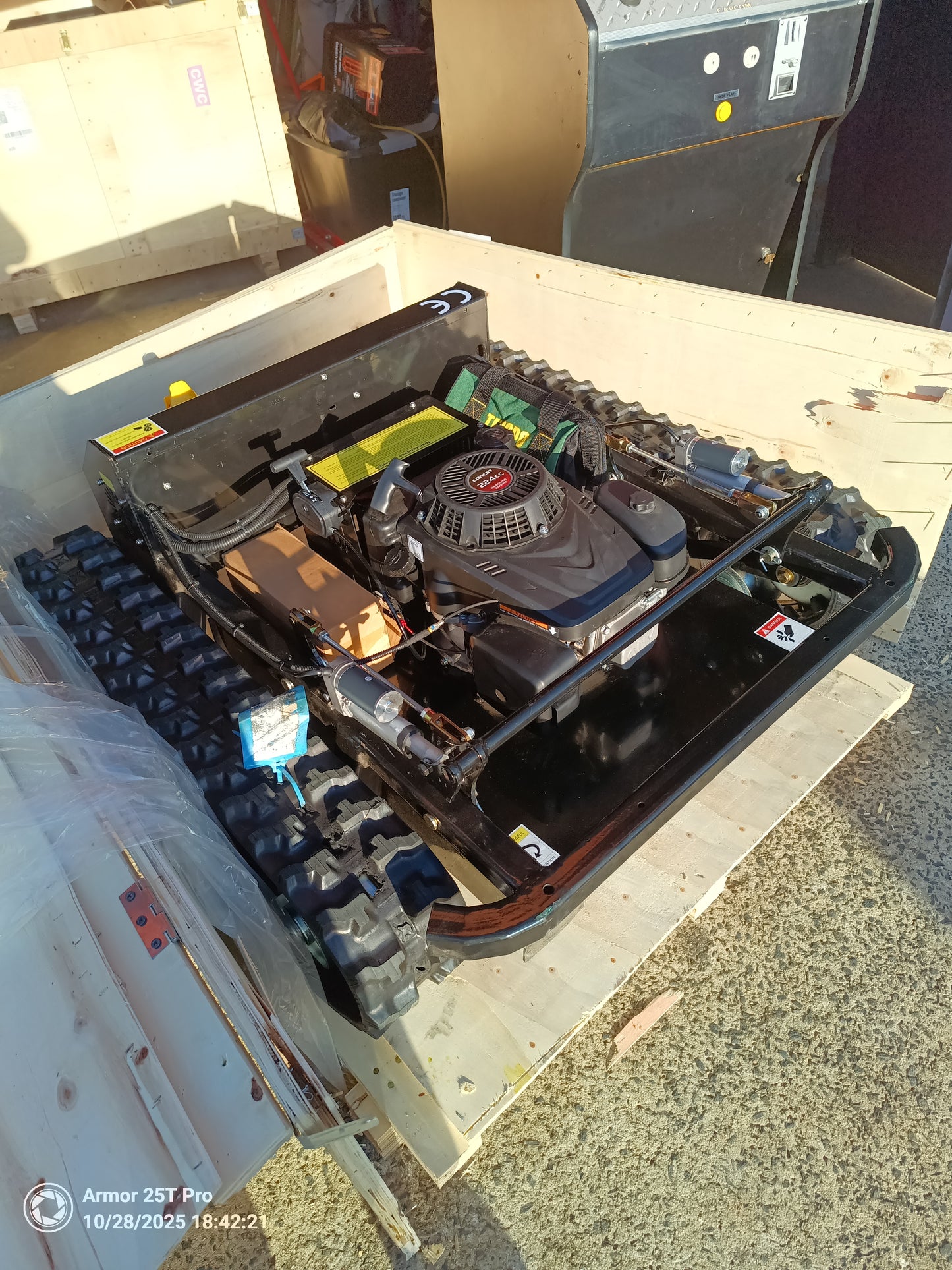 Remote control lawn mower Victoria Tank 600mm displayed in a shipping crate with powerful 9Hp engine components.