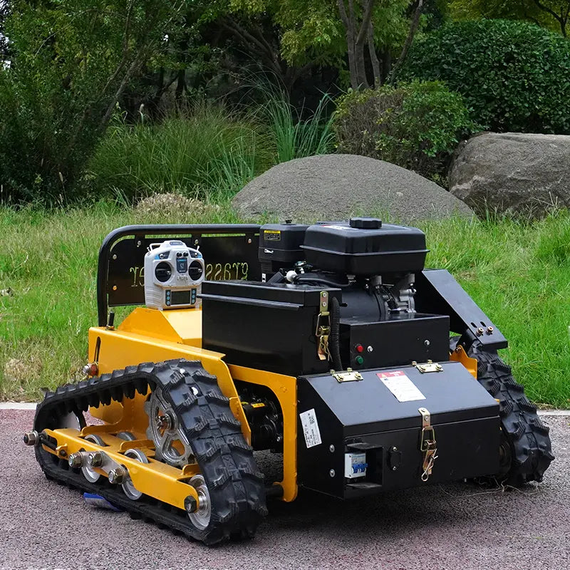 RC lawn mower on a driveway with grass and rocks in the background