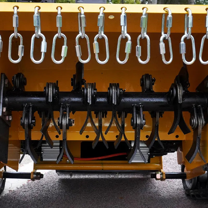 Close-up of RC lawn mower equipment with hanging hooks on a yellow background