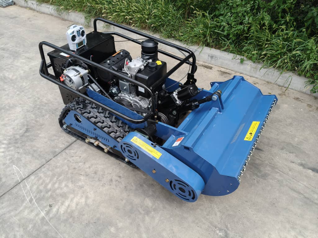 Blue tracked remote control mower with mechanical components on a concrete surface