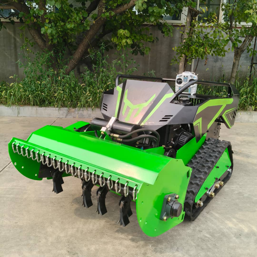 Green agricultural rc mowers with tracks on a concrete surface, surrounded by greenery.