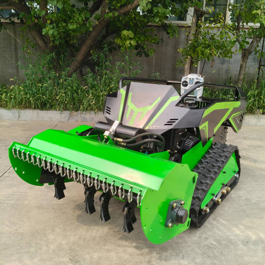 Green agricultural rc mowers with tracks on a concrete surface, surrounded by greenery.