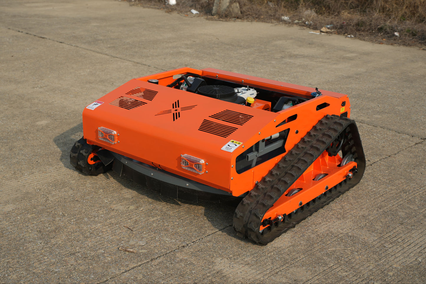 Low profile Big Bill Remote Control Lawn Mower from Rebel mowers. 45 degree climbing ability, 16 Hp 426 cc motor has sharp teeth, good table manners and eats whatever is put in front of it.