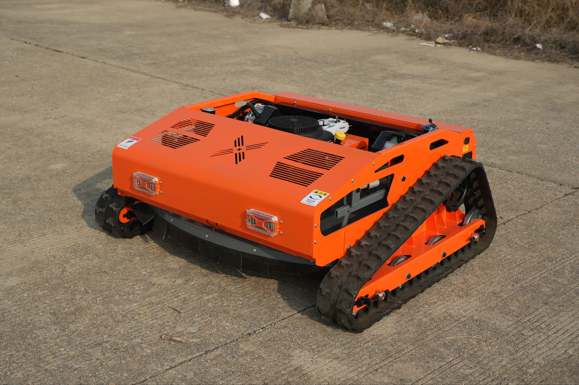 Low profile Big Bill Remote Control Lawn Mower from Rebel mowers. 45 degree climbing ability, 16 Hp 426 cc motor has sharp teeth, good table manners and eats whatever is put in front of it.