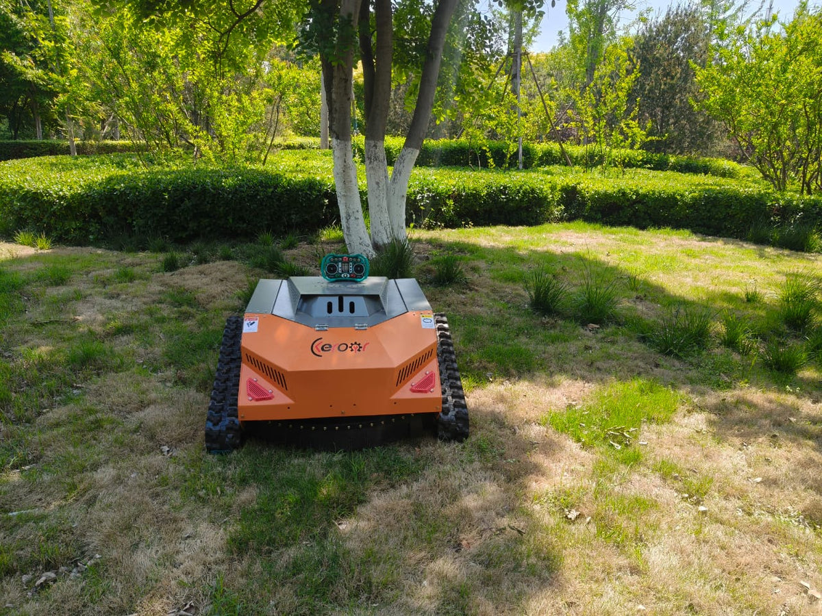 Redback remote control lawn mower operating on grassy terrain under trees.