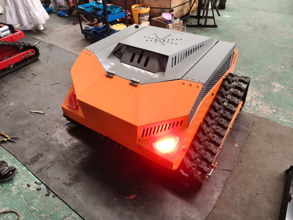 Redback remote control lawn mower with steel body and tracks, showcasing sleek design and rear lights.