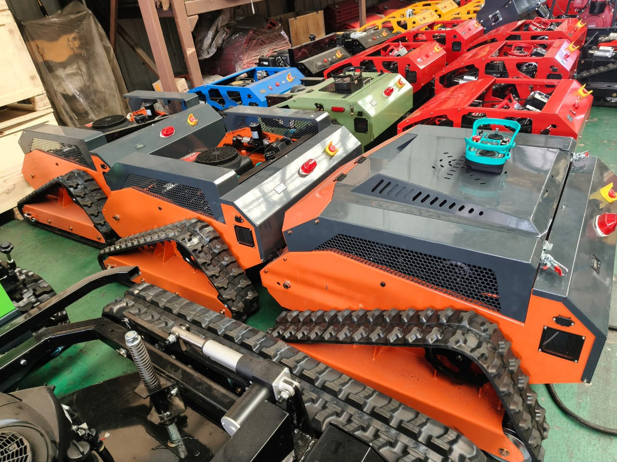 Redback remote control lawn mower showcased with vibrant colors and tracks in a warehouse setting.