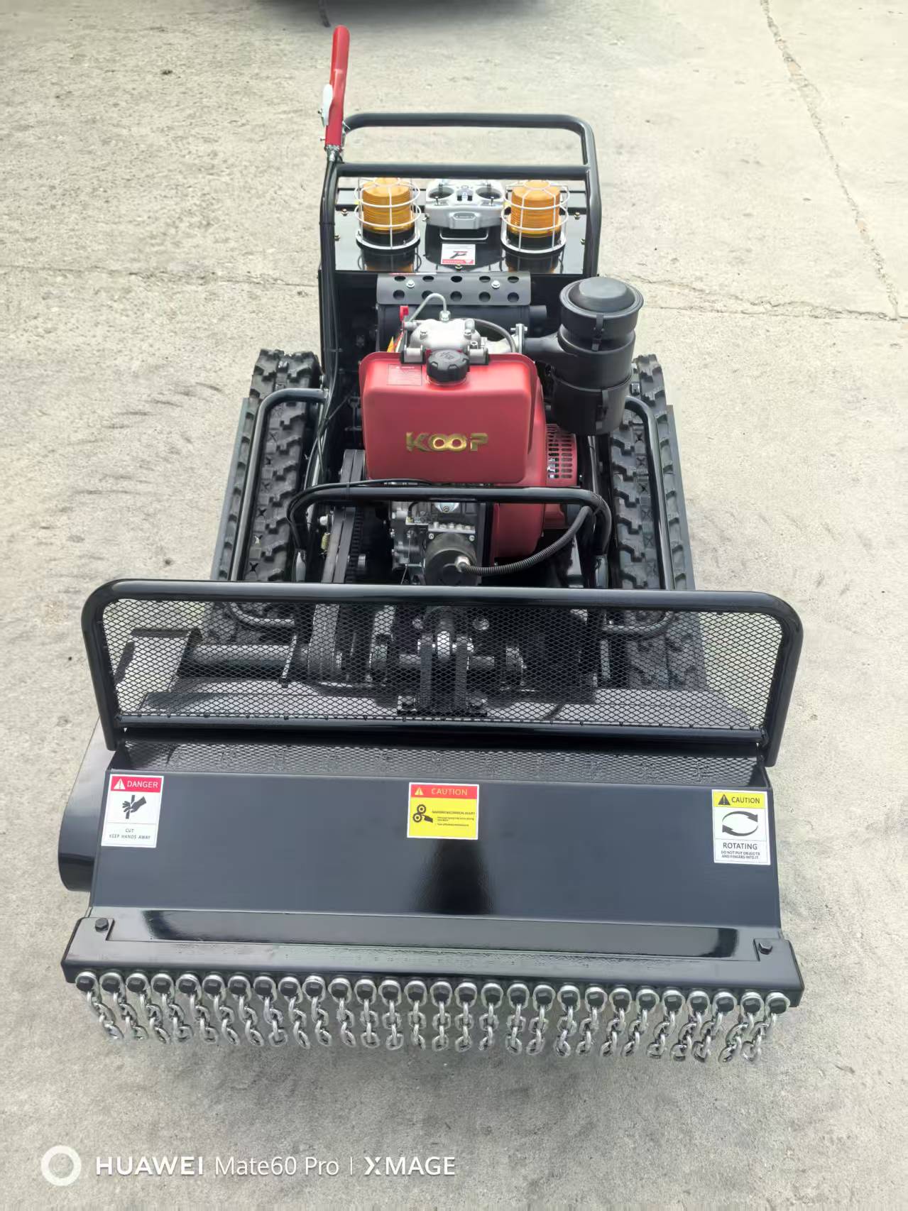 RC Lawn Mower with a red engine on a concrete surface