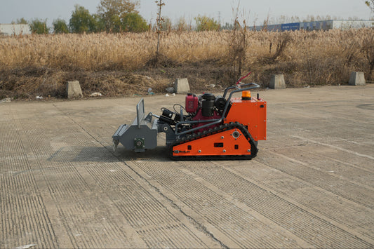 Remote Control Lawn Mower on a paved surface with dry grass and trees in the background