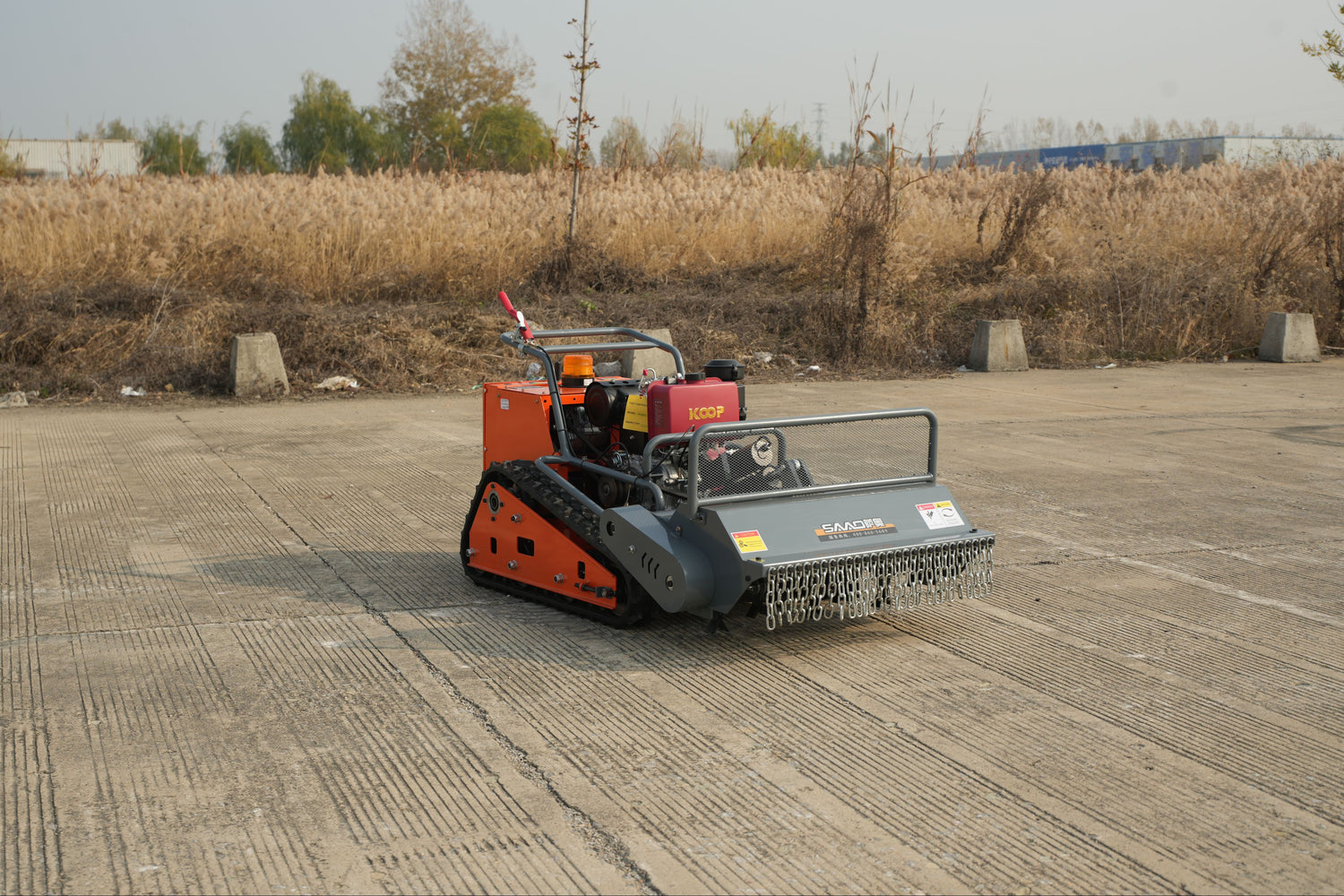 Remote Control Lawn Mower with a seeder on a flat surface, likely used for agricultural purposes.