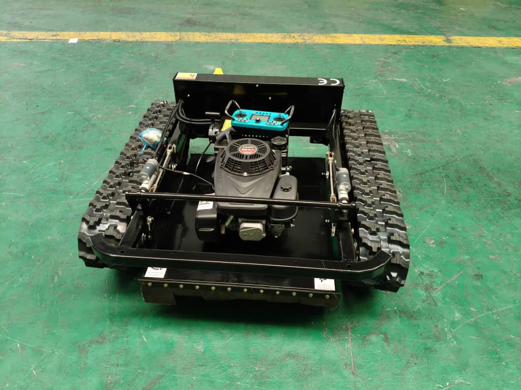 Radio controlled lawn mower with tracked drive system and 9Hp engine on a green surface.