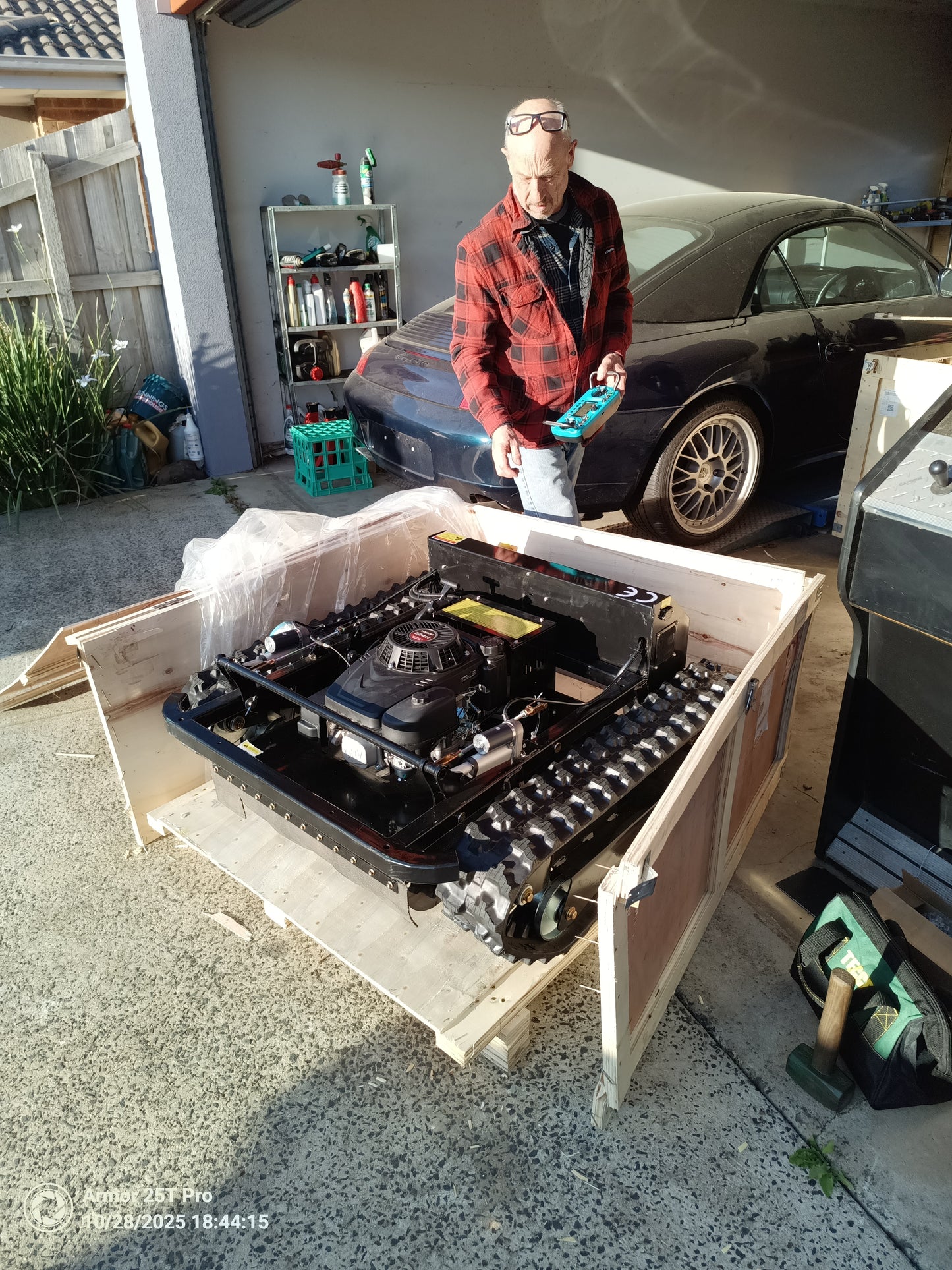 remote control lawn mower Victoria with powerful engine unpacked in garage