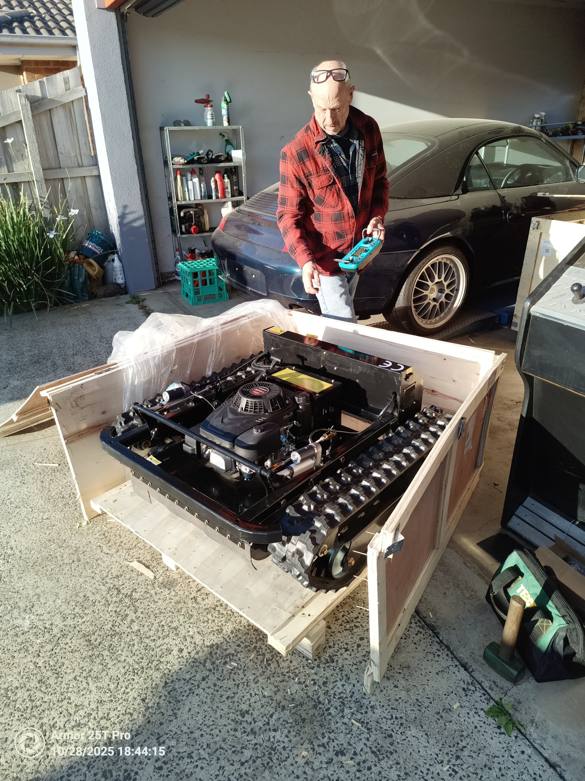 remote control lawn mower Victoria with powerful engine unpacked in garage