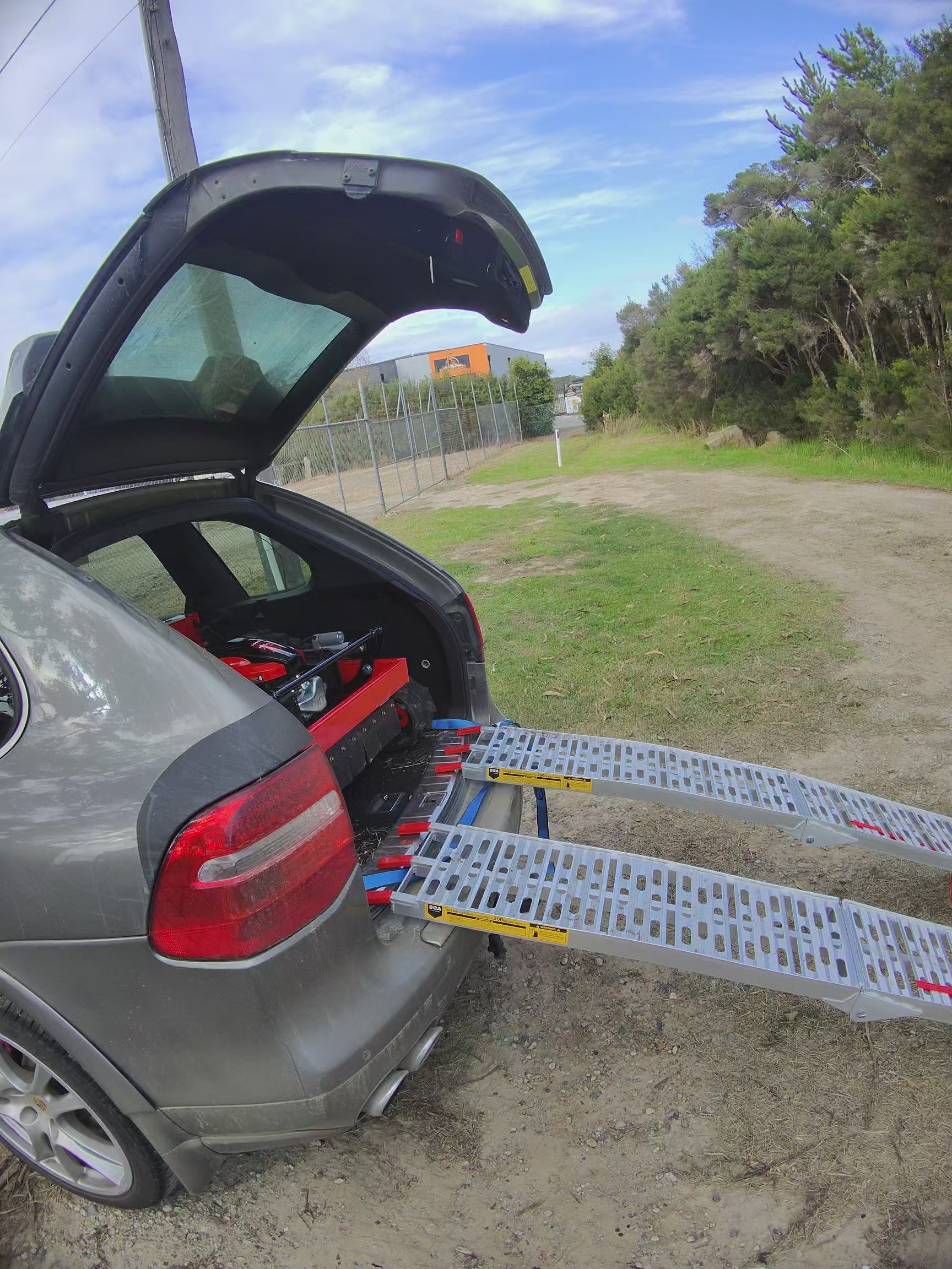 Typhoon remote control mower unloading from the back of my car. Easy to move without a trailer. Loads and unloads without the motor running www.rebelmowers.com.au